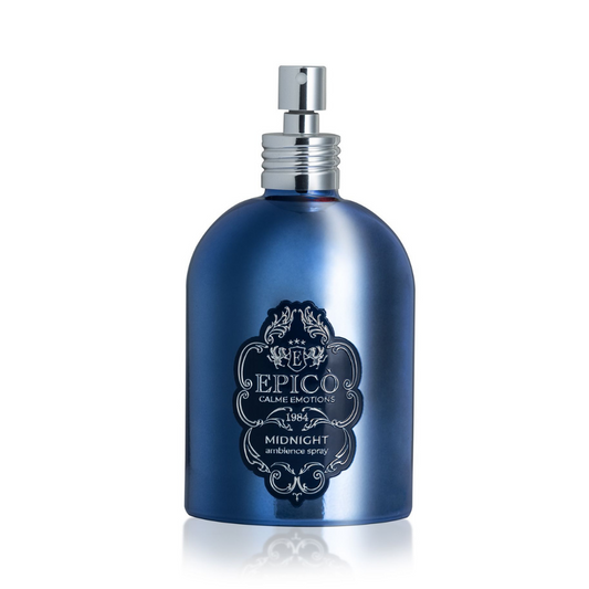 A shiny blue Epico Parfum Midnight Ambiance Spray bottle with a silver nozzle and decorative label is displayed on a white background, evoking the calming essence of this EPICO fragrance spray.