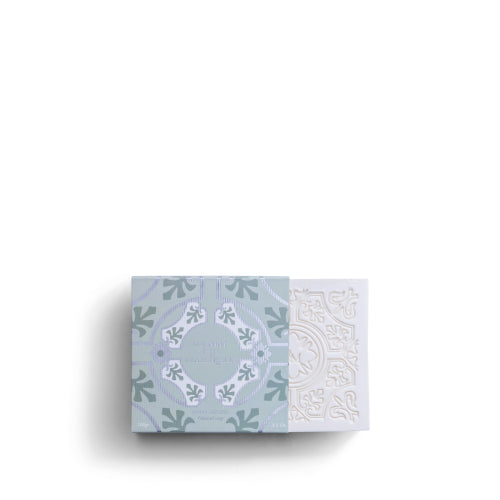 A decorative ROSE ET MARIUS SCENTED SOAP by Rose Et Marius, partially slid from its patterned pale blue and white box with intricate tile designs, sits on a plain white background. Made in France with natural perfume.