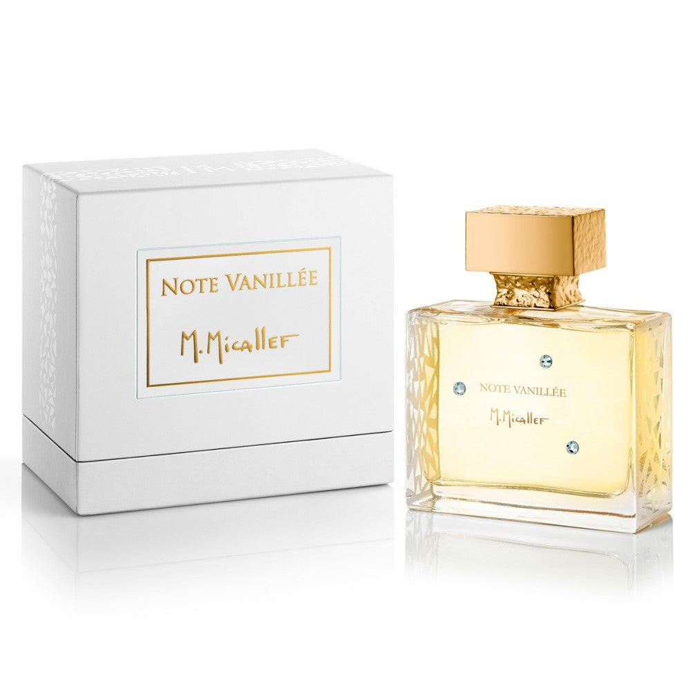 A rectangular glass bottle with a gold cap and M.Micallef label stands beside a white box marked "NOTE VANILLEE Eau de Parfum - M.Micallef" in gold. The bottle contains an amber vanilla fragrance with hints of sandalwood.