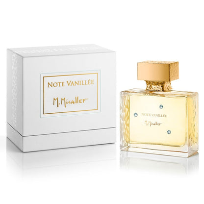 A rectangular glass bottle with a gold cap and M.Micallef label stands beside a white box marked "NOTE VANILLEE Eau de Parfum - M.Micallef" in gold. The bottle contains an amber vanilla fragrance with hints of sandalwood.
