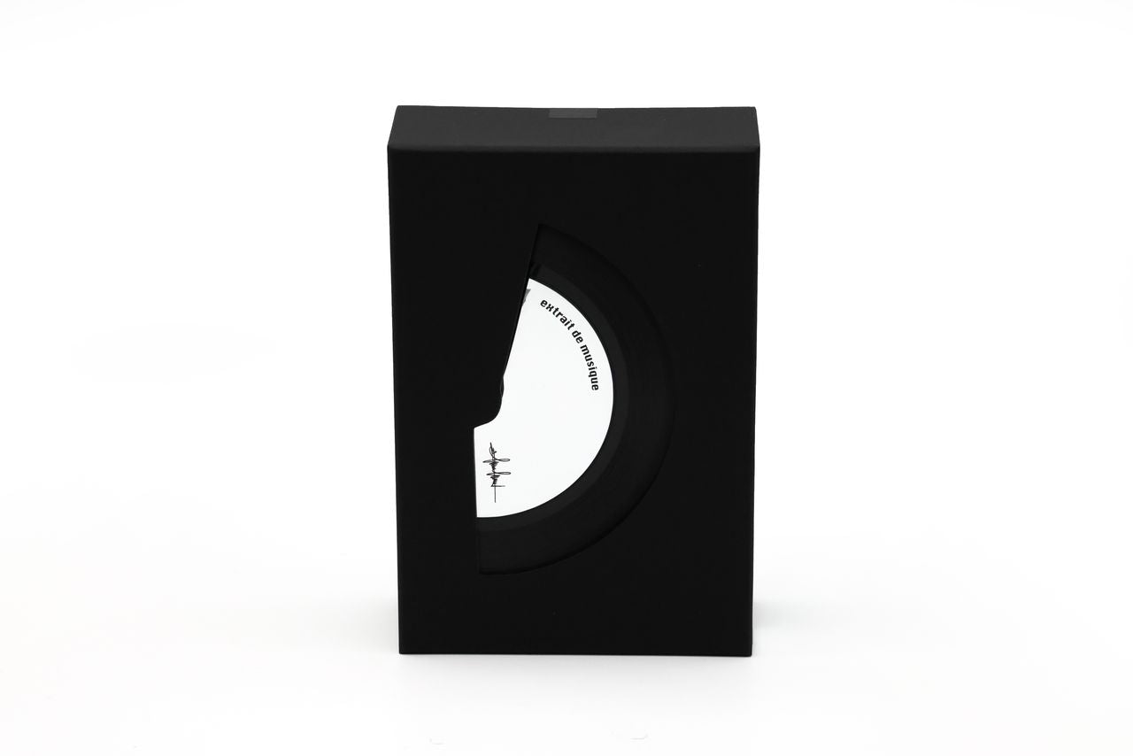 'Filippo Sorcinelli Organ Series'Black and white perfume bottle with cap on a white background.A black rectangular product box with a die-cut window showing a white circular insert featuring a minimalist face illustration and small text, photographed on a clean white background.