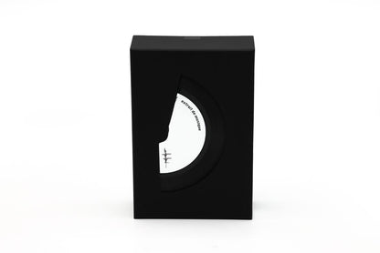 'Filippo Sorcinelli Organ Series'Black and white perfume bottle with cap on a white background.A black rectangular product box with a die-cut window showing a white circular insert featuring a minimalist face illustration and small text, photographed on a clean white background.