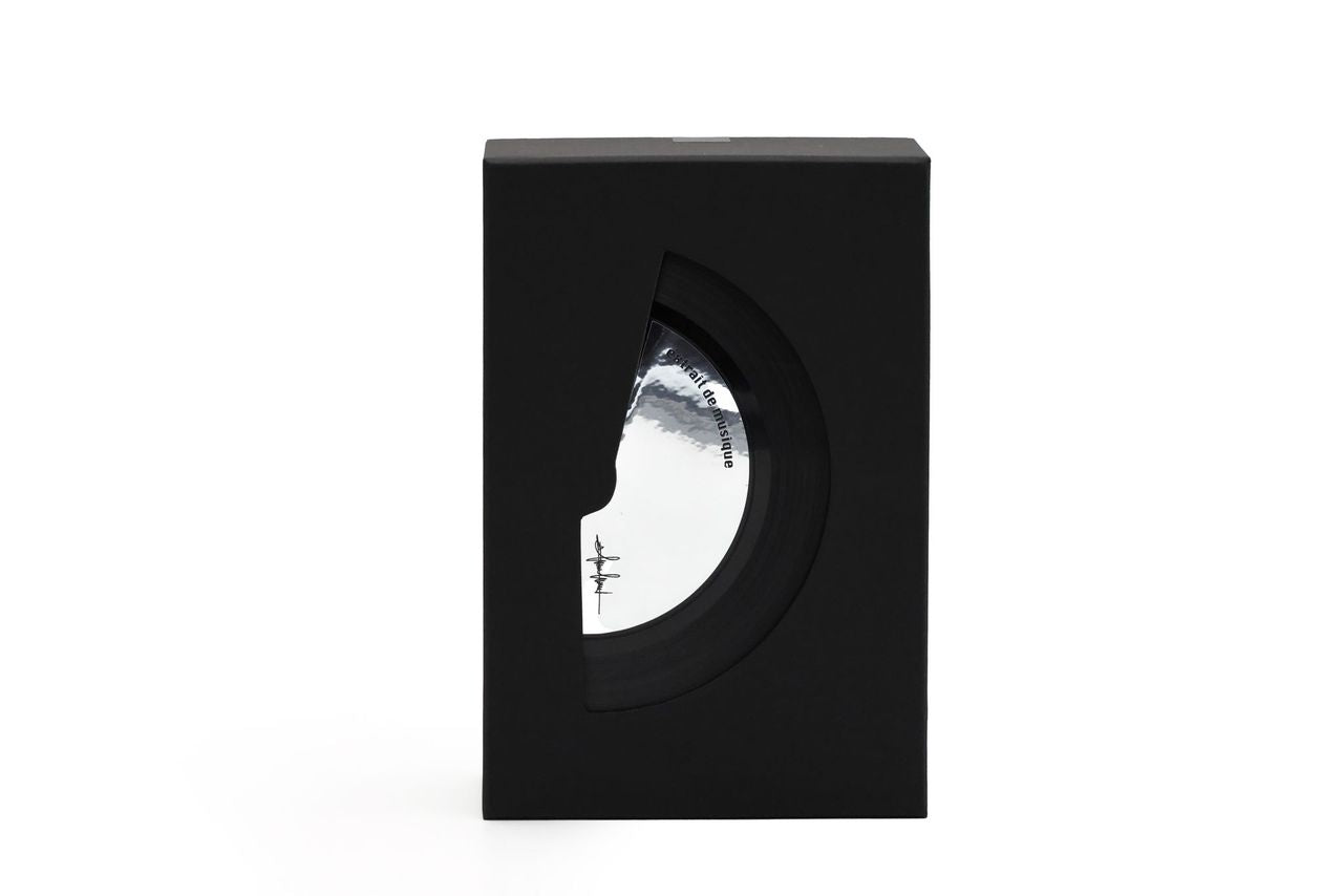A black rectangular display box with a circular cutout, showcasing a round black record sleeve inside. The sleeve features a white and gray cover design with the text 'Filippo Sorcinelli extrait de musique'
