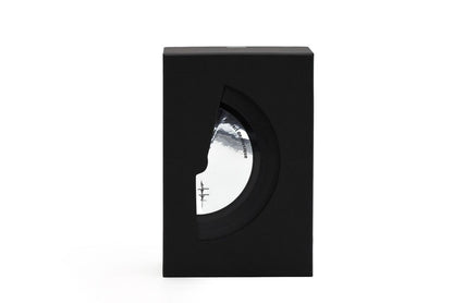 A black rectangular display box with a circular cutout, showcasing a round black record sleeve inside. The sleeve features a white and gray cover design with the text 'Filippo Sorcinelli extrait de musique'
