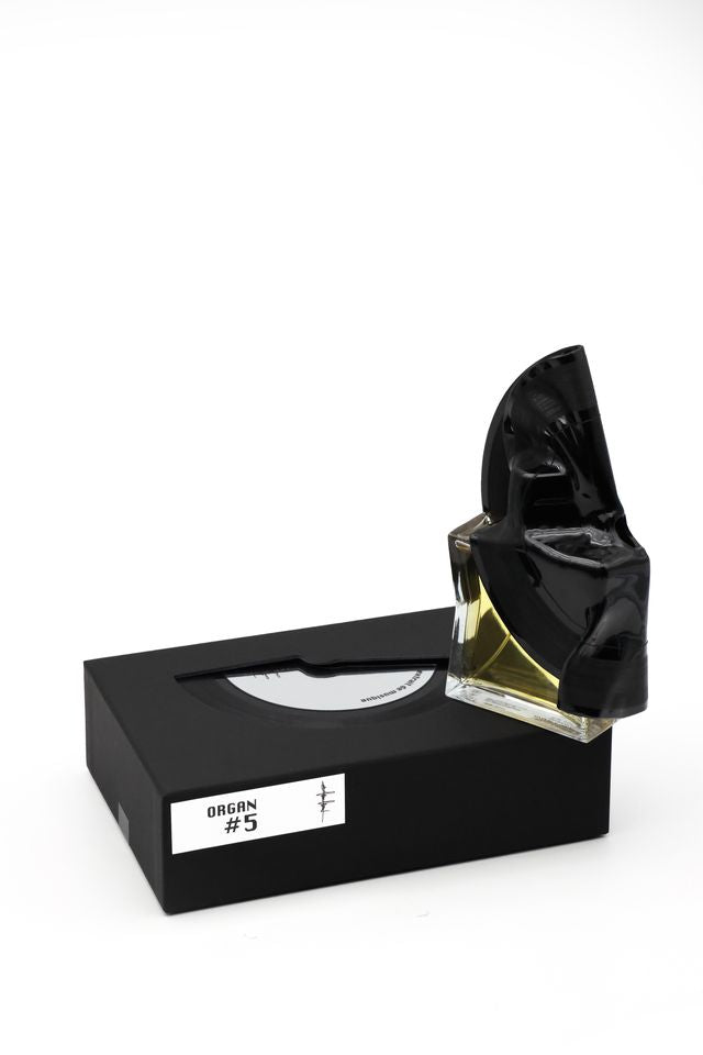 'Filippo Sorcinelli Organ #5'Black and white perfume bottle with cap on a white background