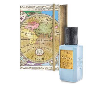 A light blue bottle of Nobile 1942’s PERDIZIONE EXCEPTIONAL EDITION EXTRAIT stands before a box with a vintage world map and gold “Special Edition Extrait” label, hinting at its unique cedarwood and floral notes.