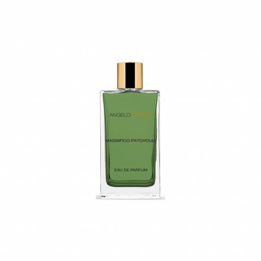 A green glass bottle of Magnifico Patchouli Eau de Parfum by ANGELO CAROLI, with a gold cap, displayed on a white background.