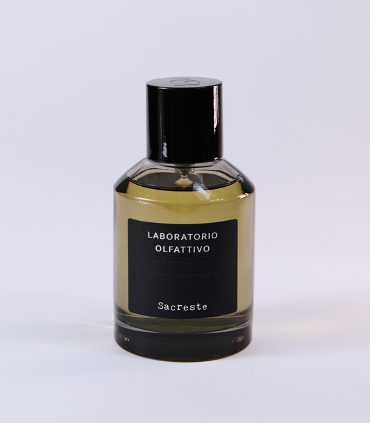 A bottle of Sacreste - Laboratorio Olfattivo by Laboratorio Olfattivo, designed by Luca Maffei, with a black cap and dark label set against a light background.