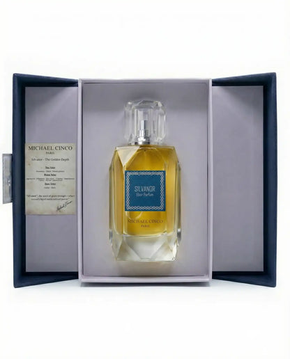 'Silvandor' by Michael Cinco  Eau de Parfum in a dark blue presentation box with a clear glass bottle containing golden-yellow liquid and a blue label.