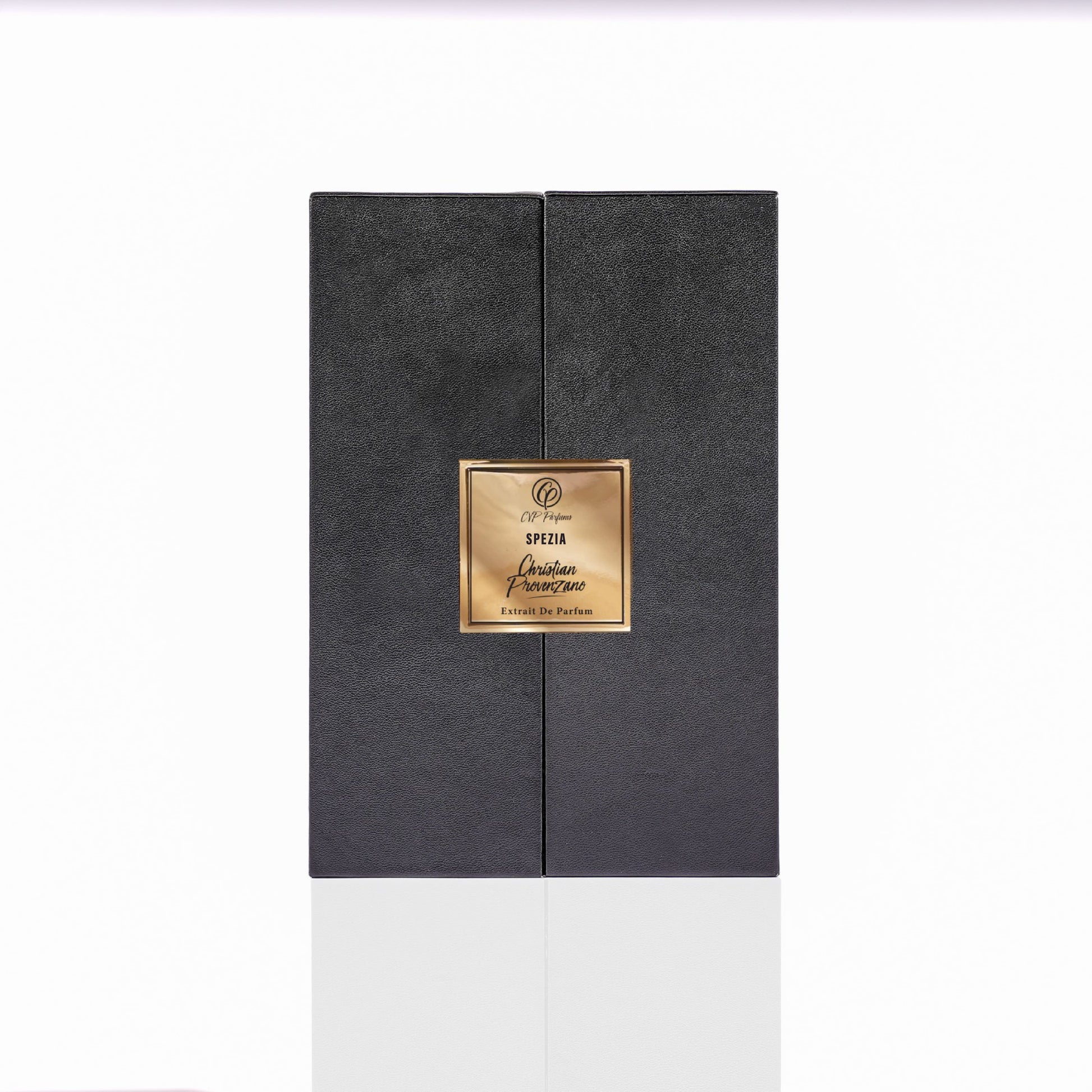 A black rectangular Spezia Eau de Parfum box by Christian Provenzano, with a textured surface and gold central label, suggests a luxurious woody scent. The box is photographed against a white background.