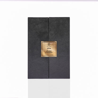 A black rectangular Spezia Eau de Parfum box by Christian Provenzano, with a textured surface and gold central label, suggests a luxurious woody scent. The box is photographed against a white background.