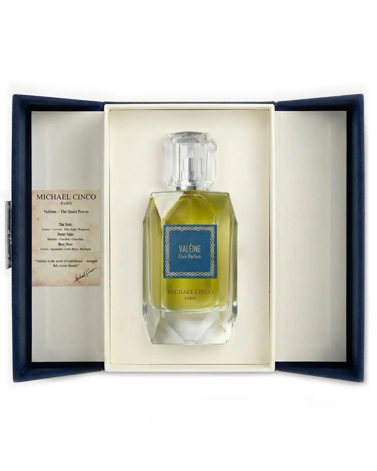 Michael Cinco 'Valéine' Eau de Parfum bottle presented in an open navy blue gift box with a cream insert and an informational card on the left.