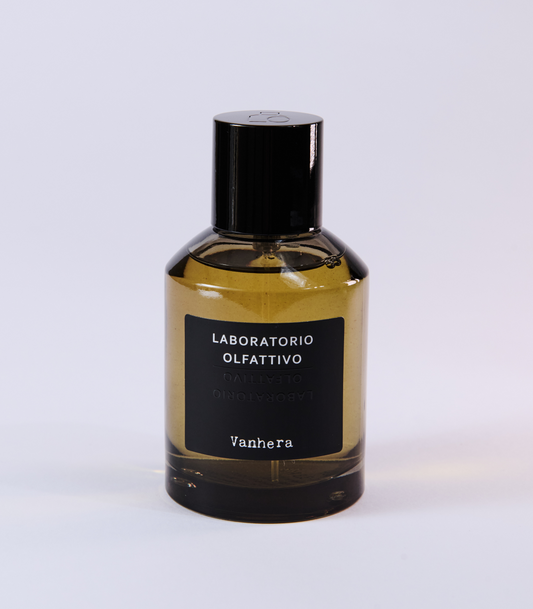A bottle of Vanhera by Laboratorio Olfattivo, with a black label and cap, is set against a white background—highlighting this elegant fragrance known for its intriguing dark vanilla scent.