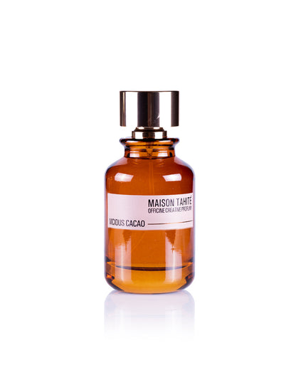 Maison Tahite's Vicious Cacao Eau de Parfum, in an amber glass bottle with a metallic cap, features rich cocoa absolute for a true gourmand fragrance and is displayed against a white background.