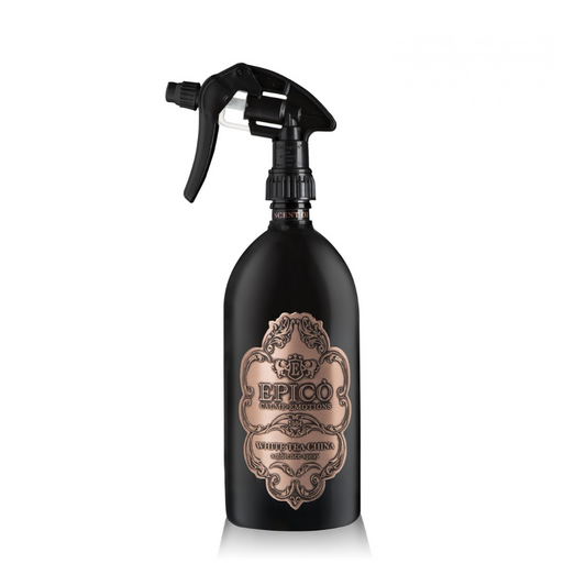 A black EPICO fragrance spray bottle labeled "White Tea China - Ambiance Spray - Epico Parfum" features a vintage-style design, rose gold accents, and trigger nozzle. Infused with sandalwood and white tea, set against a white background.